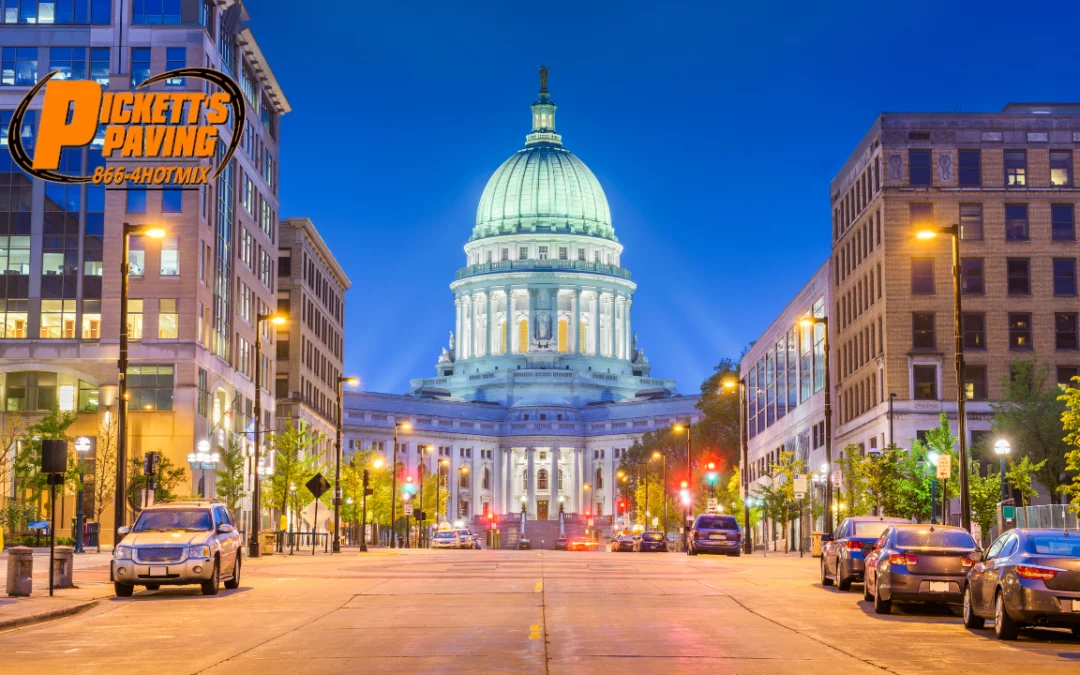View of the Capital building in Madison, WI at night with a "Pickett's Paving" logo in top left corner.